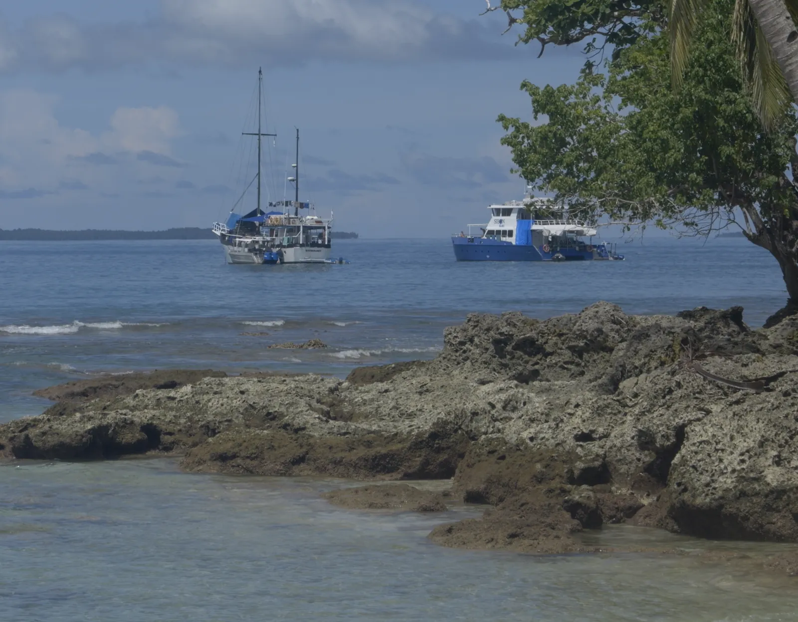 Surf charter boats anchored off a Mentawai island